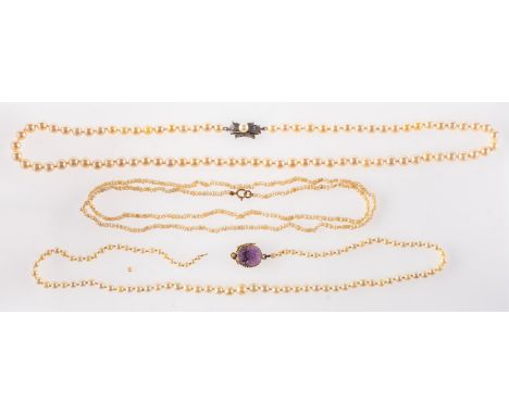 A group of three pearl necklaces, including a stand of graduated cultured pearls, approx. 3.5mm to 7.5mm, to a floral carved 
