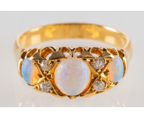 An antique opal and diamond ring, set with three oval opal cabochons and four small old-cut diamonds, unmarked, tests as 18ct