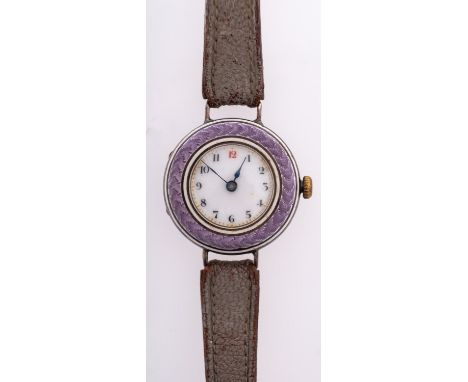 An Edwardian purple enamel and silver wristwatch the round dial with black Arabic numerals and red 12 o'clock numeral, blued 