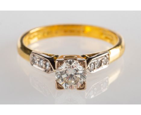 An 18ct gold diamond ring, square set to the centre with a brilliant-cut diamond, diamond approx. 0.50 carat, with three bril
