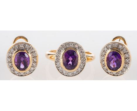 An amethyst and diamond ring and earrings, the ring set with an oval mixed-cut amethyst with a surround of brilliant-cut diam