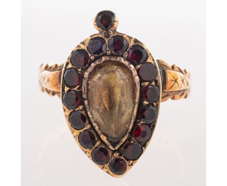 A Victorian memorial ring, set to the centre with a pear-shaped citrine, surrounded by circular-cut garnets in a pear shaped 