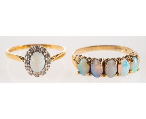 A group of two opal rings, an 18ct gold cluster ring set with an oval opal cabochon with a surround of single-cut diamonds, U