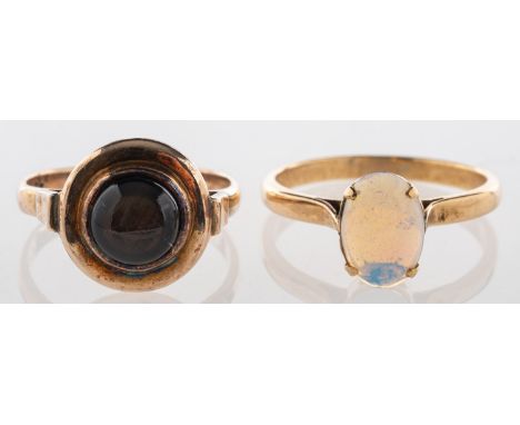 A group of two rings, including a ring set with an oval-cut opal cabochon, unmarked & untested, size L, 2.0grams; and a ring 