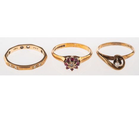 A group of three rings, including a 9ct gold twist ring set with a small brilliant-cut diamond, UK hallmark, size L to L1/2, 