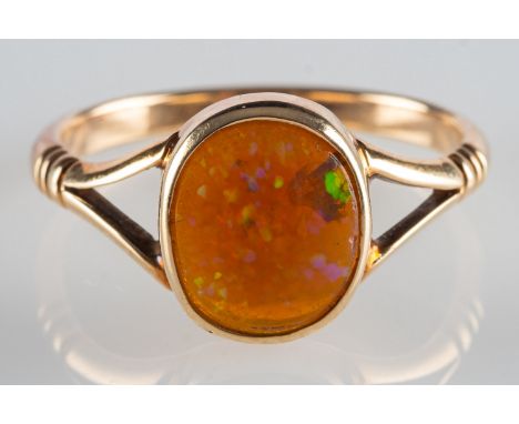 An opal ring, collet set with an oval Ethiopian opal cabochon, measuring approx. 9.3mm x 7.8mm x 3.05mm, unmarked, tests as 9