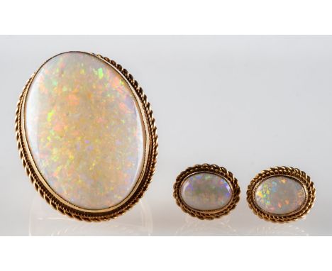 A 1970's 9ct gold opal ring and earrings, a cocktail ring set with an oval opal cabochon in a rope twist mount, UK hallmark, 