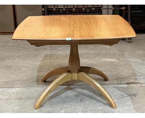 An Ercol Windsor model 1192 pedestal dining table with concealed leaf. 41" long retracted.