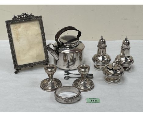 A silver hinged bangle, a pair of loaded silver squat candlesticks and miscellaneous plate.
