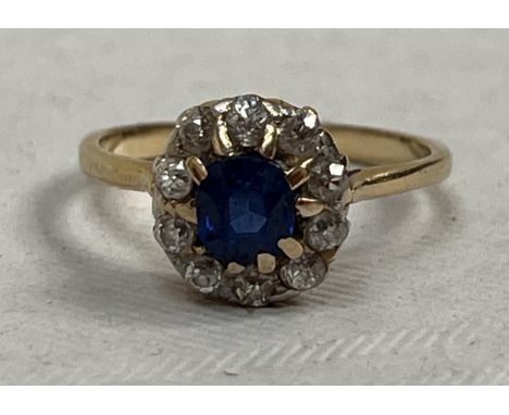 A sapphire and diamond cluster ring. In gold marked 18ct. 3g gross. Size L.