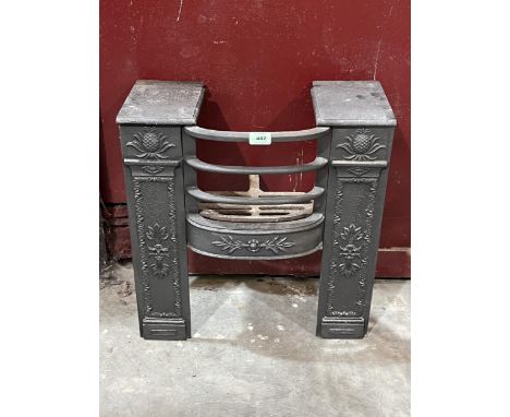 A 19th Century cast iron fire grate. 20" wide.