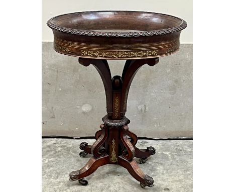 An early Victorian rosewood and brass inlaid jardiniere in the manner of George Bullock, the gadrooned oval basin on quadripa
