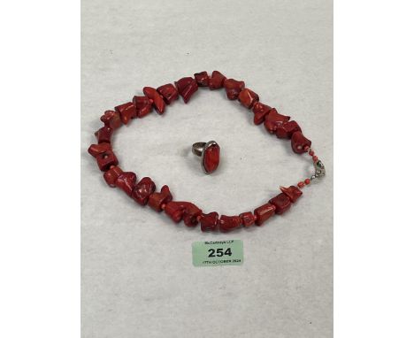 A red coral necklace and a silver coral dress ring.