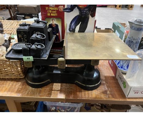 A set of weighing scales and weights.