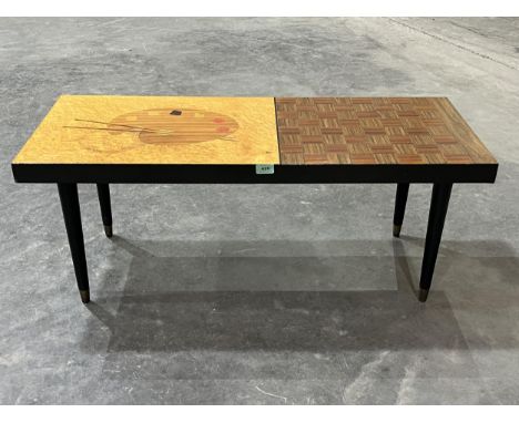 A mid-20th Century low table, the top with artist's palette and chessboard inlay. 40" wide.