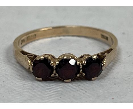 A 9ct three stone garnet ring. 1g gross, size L.