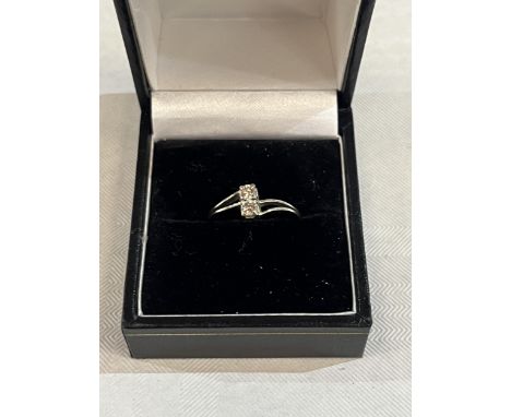 A 14ct two stone diamond ring. 1.6g gross, size K.