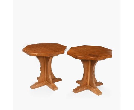 A pair of Robert Mouseman Thompson oak side tables, each with adzed octagonal top on curved cruciform pedestal, carved mouse 