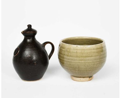 Leach Potterya stoneware pourer and cover, covered in a textured tenmoku glaze, and a Leach Pottery footed bowl covered in a 