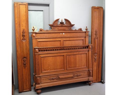 A 19th century French oak double bed, with double panel head and foot board, 142cm wide x 167cm high.
