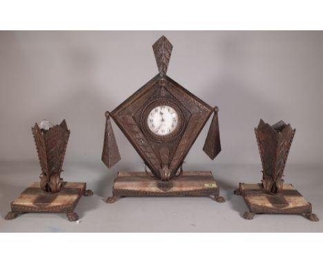 An Art Nouveau composite metal and onyx mantel clock with garnitures, 29cm wide x 45cm high. 