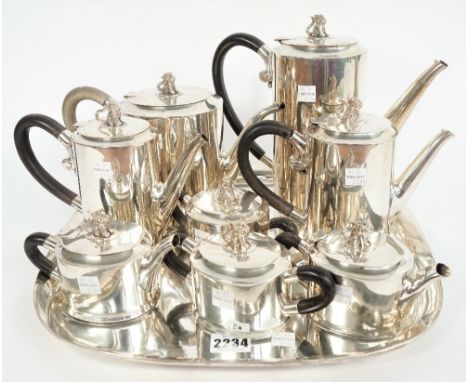 A Mexican nine piece silver tea/coffee service, each of the eight hollow ware pieces of oval form, having black handles and w