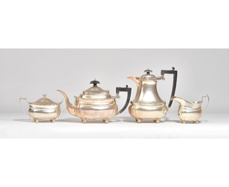 A silver four piece tea set, comprising; a teapot and a hot water jug, having black handles and finials to the hinged lids, a