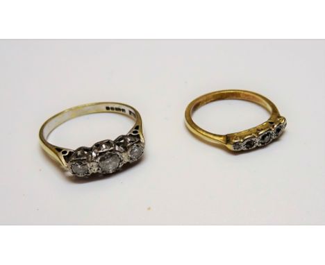 An 18ct gold and diamond set three stone ring, mounted with a row of circular cut diamonds and with the principal diamond mou