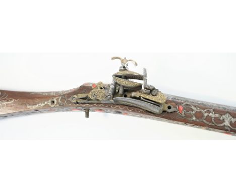 A North African (Algiers) toe-lock musket, early 19th century, with etched twist barrel inlaid with silver foliage at the muz