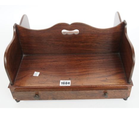 An early Victorian rosewood twin shelf book carrier, with single frieze drawer, 37cm wide x 20cm high. 