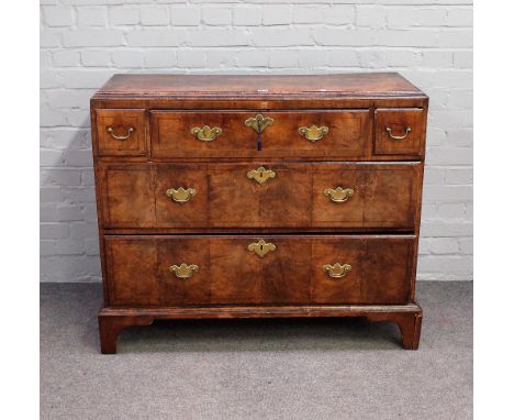 A George I walnut secretaire chest, the fitted drawer flanked by two short over two long drawers on bracket feet, 106cm wide 