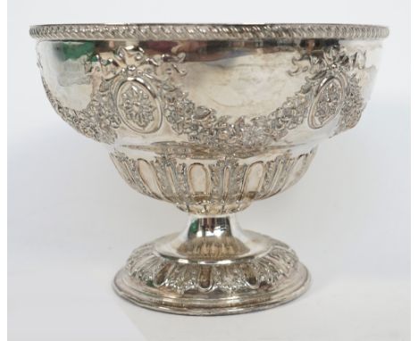 A silver bowl, of circular form, embossed with floral and foliate swags, alternating with oval medallions, having bow surmoun