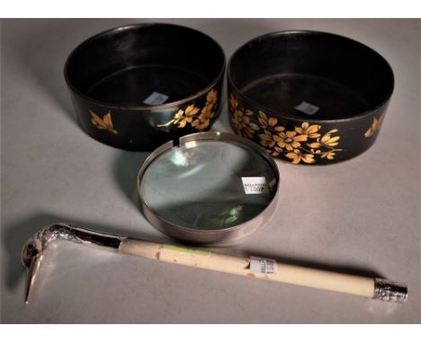 A silver mounted magnifying glass with swan head handle, (a.f.) and a pair of black lacquer and gilt decorated bottle coaster