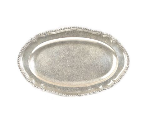 A George III silver shaped oval serving dish, having a decorated rim, armorial engraved, length 37cm, London 1766, weight 866