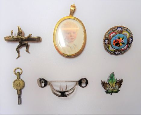 A gold mounted oval pendant locket, detailed 15 CT, glazed with a portrait miniature of a child , four brooches and a watch k