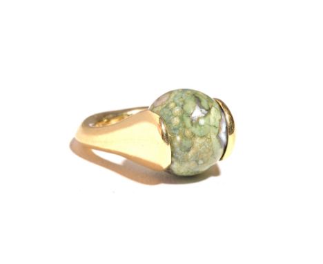 A gold ring, mounted with a spherical green agate bead, detailed 14 K (possibly loaded), ring size G (note shank is not circu