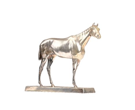 A silver plated model of a standing horse, on a rectangular rustic base, length of base 20cm. Illustrated.