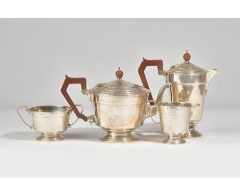 Silver tea wares, comprising; a teapot with brown composition fittings, Birmingham 1930, a hot water jug, with brown composit