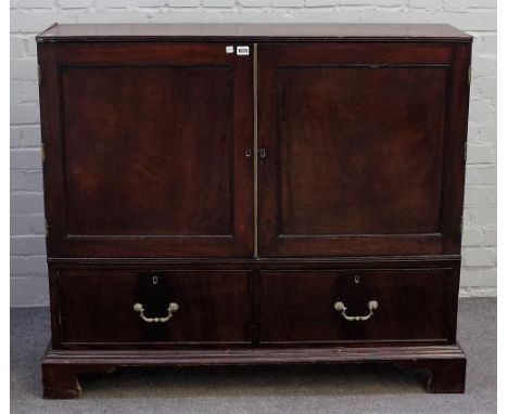 A George III mahogany side cabinet, the pair of panel doors enclosing a fitted interior with seventeen pigeon holes over four