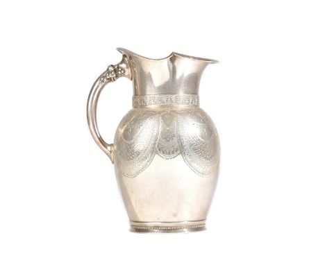 An American silver water jug, the body with engraved decoration, otherwise with a monogram to the front, the handle decorated