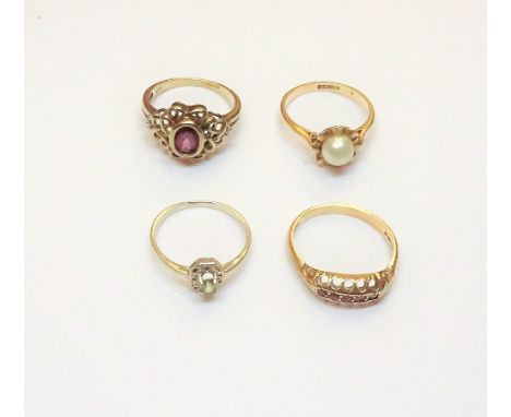 A 9ct gold and ruby set five stone ring, a 9ct gold, diamond and red gem set ring, decorated with pierced shoulders, a 9ct go