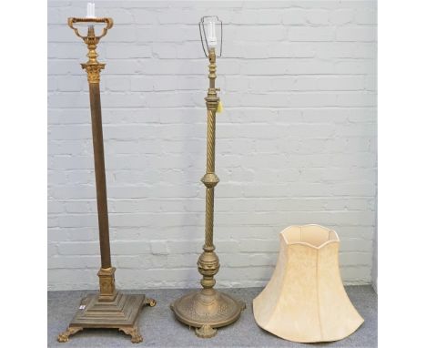 A gilt metal standard lamp of corinthian column form, raised on four lion paw feet and one further gilt metal standard lamp, 