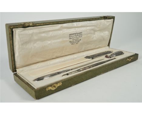 A French silver mounted four piece desk set, comprising; a page turner, a paper knife, a seal and a dip pen, with a case.