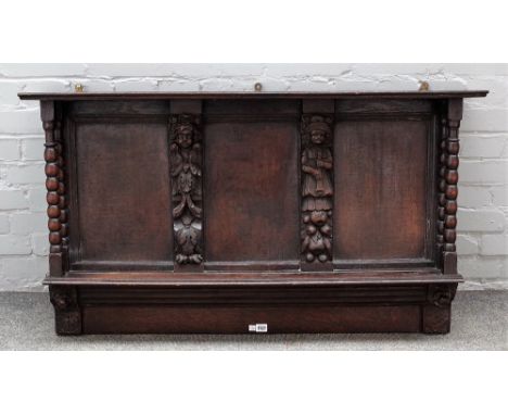 A 17th century and later oak wall shelf, with carved figural pilasters and turned supports, 110cm wide x 65cm high. 