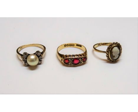 An 18ct gold, red gem and diamond set ring, Birmingham 1918, gross weight 3.4 gms, a gold and oval shell cameo ring, detailed