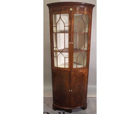 A late 18th century walnut floor standing bow fronted corner display cabinet with astragal glazed doors on bracket feet, 75cm