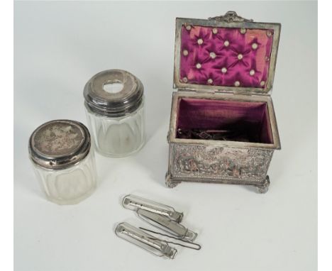 A silver plated on copper rectangular hinge lidded trinket box, the lid and the sides decorated with figures, horses and anim