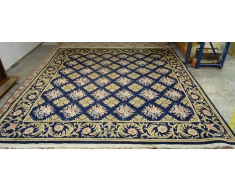 A Kashan carpet, Persian, the indigo field with diamond shaped floral leaf motifs, a complementary border of scrolling leaves