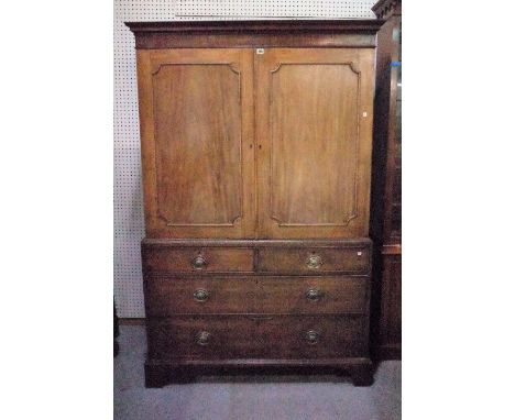 A George III mahogany linen press with moulded panelled doors over two short and two long graduated drawers on bracket feet, 