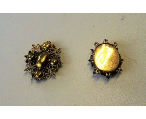 A pink foil backed topaz cannetille work clasp, a pink foil backed topaz cannetille work oval panel and part of a gilt metal 